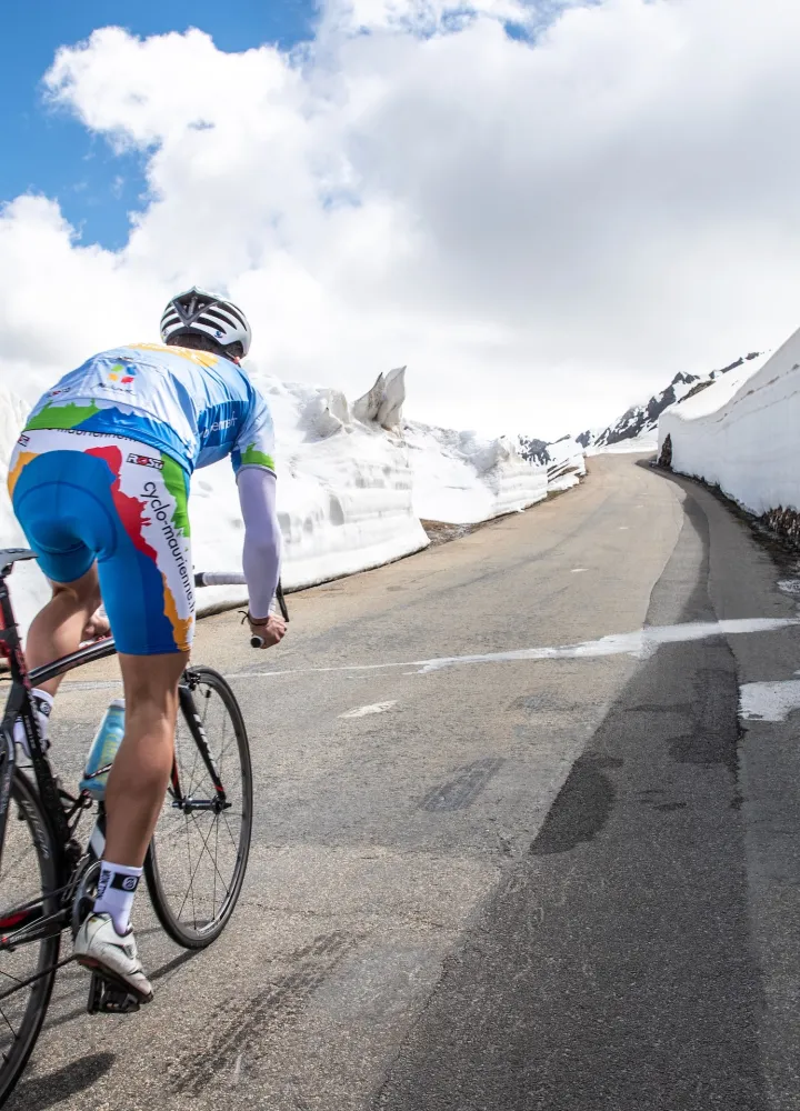 Cycliste dans la neige sur Route des Grandes Alpes