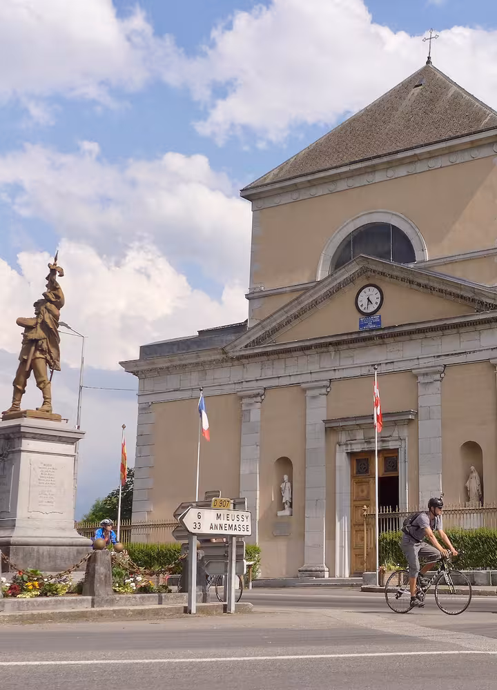 Cyclistes devant l'Église Saint-Jean-Baptiste de Taninges